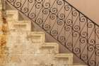 Stone staircase with ornate wrought iron balustrade. Greece, Crete, Chania. Art Print